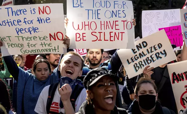 Michael Martinez joins several hundred demonstrators rallying against President Donald Trump outside the California State Capitol on Wednesday, Feb. 5, 2025, in Sacramento, Calif. (AP Photo/Noah Berger)