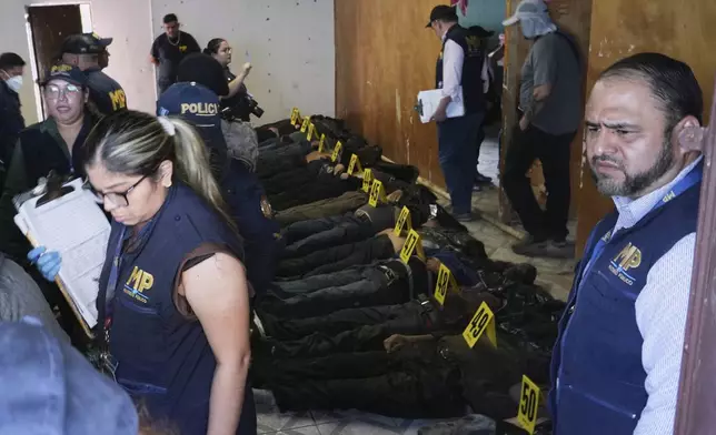 The bodies of passengers who died in a bus crash are lined up on the floor at a makeshift morgue near the site of the accident on the outskirts of Guatemala City, Monday, Feb. 10, 2025. (AP Photo/Moises Castillo)