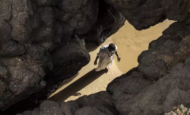 Dressed in white robes to symbolize purity and equality before God, followers from the Layene brotherhood commemorate the first public appearance of their founder Seydina Limamou Laye in 1884 at Yoff's beachside mosque in Dakar, Senegal, Friday, Jan. 31, 2025. (AP Photo/Annika Hammerschlag)