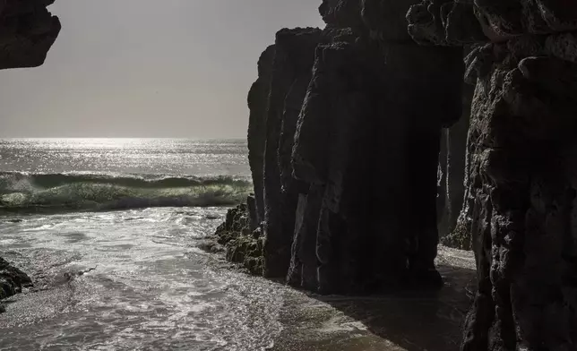 Waves from the Atlantic ocean break on a scared grotto where followers of the Layene brotherhood believe their prophet received divine inspiration, in Dakar, Senegal, Thursday, Jan. 30, 2025. (AP Photo/Annika Hammerschlag)