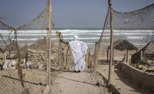 Dressed in white robes to symbolize purity and equality before God, followers from the Layene brotherhood commemorate the first public appearance of their founder Seydina Limamou Laye in 1884 at Yoff's beachside mosque in Dakar, Senegal, Friday, Jan. 31, 2025. (AP Photo/Annika Hammerschlag)