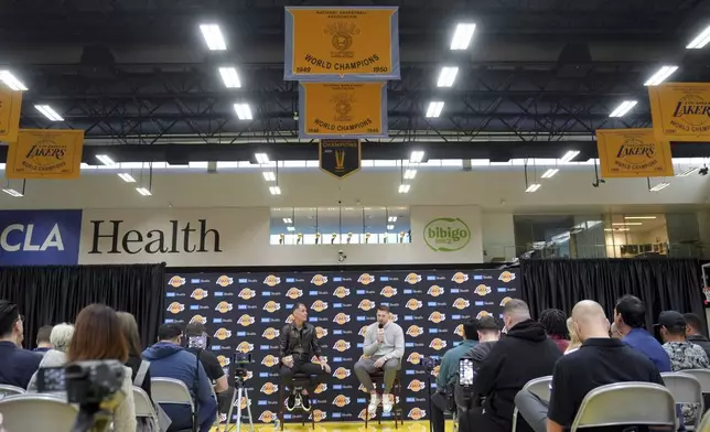 Los Angeles Lakers' Luka Doncic speaks next to general manager Rob Pelinka during an introductory NBA basketball press conference Tuesday, Feb. 4, 2025, in El Segundo, Calif. (AP Photo/Jae C. Hong)