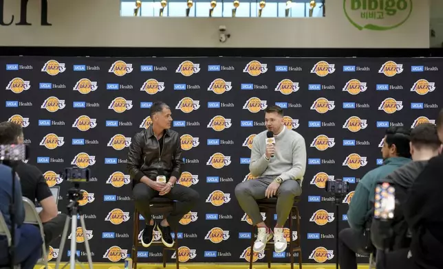 Los Angeles Lakers' Luka Doncic speaks next to general manager Rob Pelinka during an introductory NBA basketball press conference Tuesday, Feb. 4, 2025, in El Segundo, Calif. (AP Photo/Jae C. Hong)