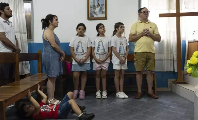 Faithful pray for the health of Pope Francis at Caacupe church in the Carlos Mugica neighborhood in Buenos Aires, Argentina, Sunday, Feb. 23, 2025. (AP Photo/Rodrigo Abd)