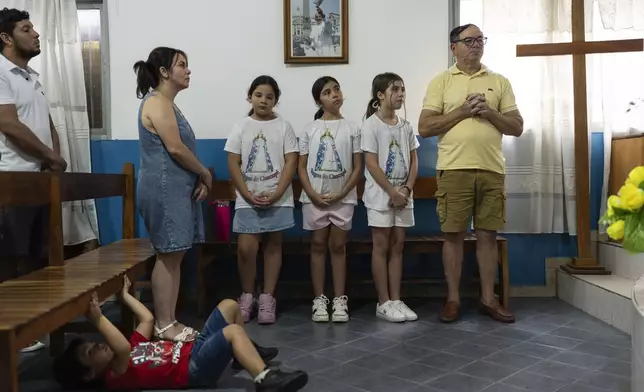 Faithful pray for the health of Pope Francis at Caacupe church in the Carlos Mugica neighborhood in Buenos Aires, Argentina, Sunday, Feb. 23, 2025. (AP Photo/Rodrigo Abd)