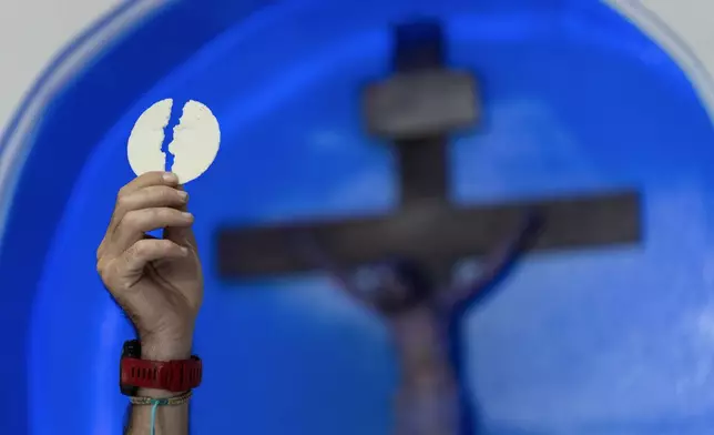 Priest Agustin Lopez leads a Mass for the health of Pope Francis at Caacupe church in the Carlos Mugica neighborhood in Buenos Aires, Argentina, Sunday, Feb. 23, 2025. (AP Photo/Rodrigo Abd)