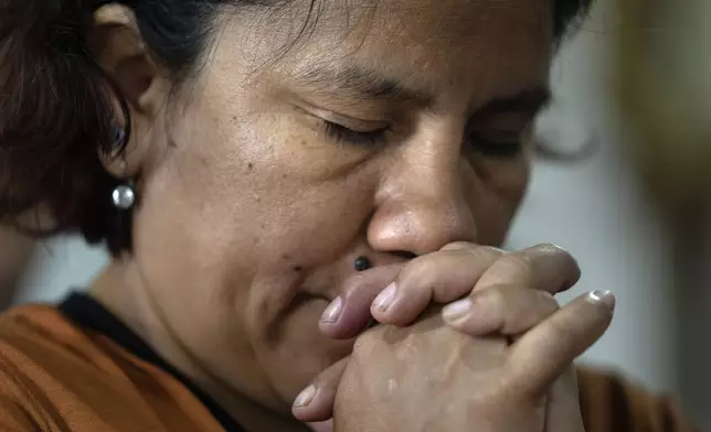 A woman prays at the Rosario church in Carlos Mugica neighborhood, Buenos Aires, Argentina, Sunday, Feb. 23, 2025. (AP Photo/Rodrigo Abd)