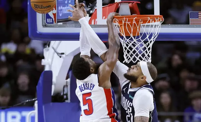 Dallas Mavericks center Daniel Gafford (21) defends against a shot by Detroit Pistons guard Malik Beasley (5) during the first half of an NBA basketball game Friday, Jan. 31, 2025, in Detroit. (AP Photo/Duane Burleson)