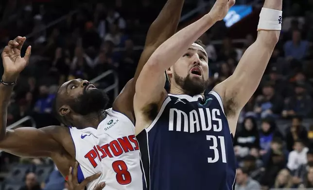 Dallas Mavericks guard Klay Thompson (31) goes to the basket past Detroit Pistons forward Tim Hardaway Jr. (8) during the first half of an NBA basketball game Friday, Jan. 31, 2025, in Detroit. (AP Photo/Duane Burleson)
