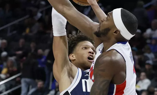 Dallas Mavericks forward Kessler Edward, left, loses the ball against Detroit Pistons forward Paul Reed, right, during the first half of an NBA basketball game Friday, Jan. 31, 2025, in Detroit. (AP Photo/Duane Burleson)