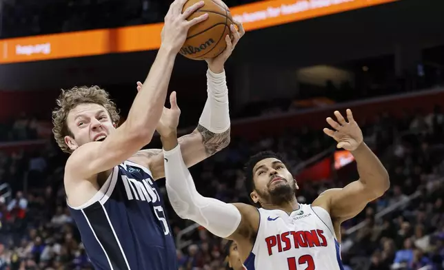 Dallas Mavericks center Kylor Kelley, left, beats Detroit Pistons forward Tobias Harris (12) to a rebound during the first half of an NBA basketball game Friday, Jan. 31, 2025, in Detroit. (AP Photo/Duane Burleson)