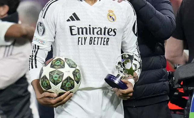 Real Madrid's Kylian Mbappe grimaces after the Champions League playoff second leg soccer match between Real Madrid and Manchester City at the Santiago Bernabeu Stadium in Madrid, Spain, Wednesday, Feb. 19, 2025. (AP Photo/Manu Fernandez)