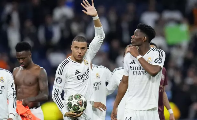 Real Madrid's Kylian Mbappe celebrates after the Champions League playoff second leg soccer match between Real Madrid and Manchester City at the Santiago Bernabeu Stadium in Madrid, Spain, Wednesday, Feb. 19, 2025. (AP Photo/Manu Fernandez)