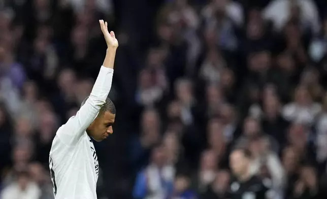 Real Madrid's Kylian Mbappe greets fans during the Champions League playoff second leg soccer match between Real Madrid and Manchester City at the Santiago Bernabeu Stadium in Madrid, Spain, Wednesday, Feb. 19, 2025. (AP Photo/Manu Fernandez)