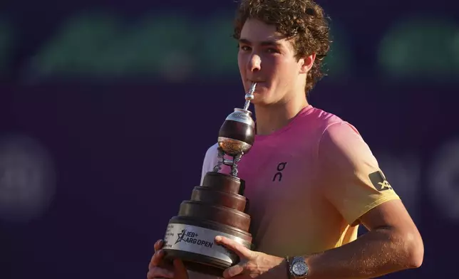 Brazil's Joao Fonseca poses with the trophy after defeating Argentina's Francisco Cerundolo in a men's doubles final match at the Argentina Open ATP tennis tournament at Guillermo Vilas Stadium in Buenos Aires, Argentina, Sunday, Feb. 16, 2025. (AP Photo/Gustavo Garello)