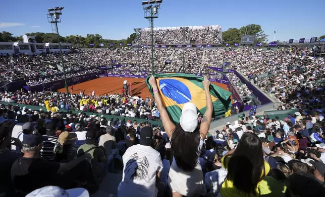Fans of Brazil's Joao Fonseca cheer during a men's doubles final match against Argentina's Francisco Cerundolo at the Argentina Open ATP tennis tournament at Guillermo Vilas Stadium in Buenos Aires, Argentina, Sunday, Feb. 16, 2025. (AP Photo/Gustavo Garello)