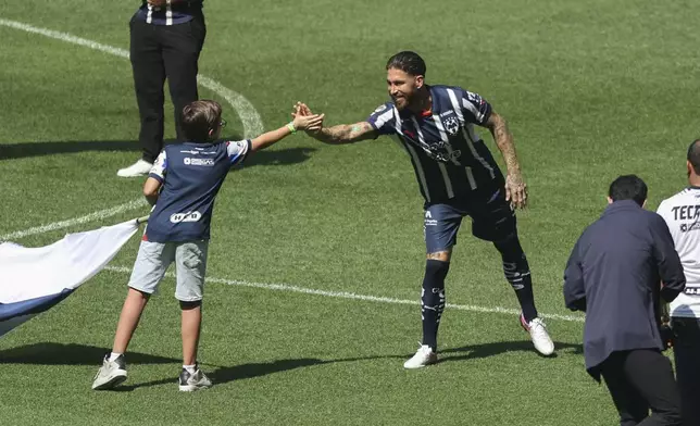 Spanish soccer player Sergio Ramos shakes a young fan's hand during his presentation at Monterrey, his new soccer club, in Monterrey, Mexico, Sunday, Feb. 9, 2025. (AP Photo/Jorge Mendoza)