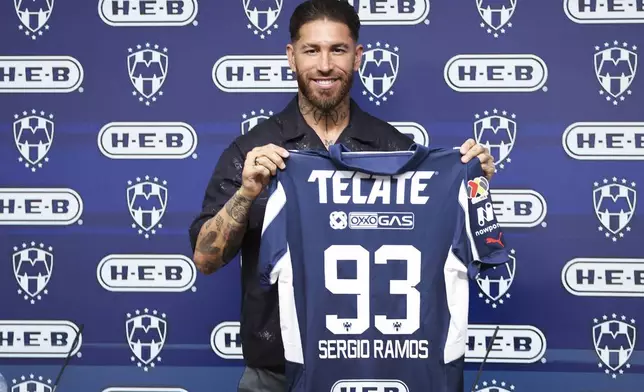Spanish soccer player Sergio Ramos holds up his jersey during a press conference with Monterrey, his new soccer club, in Monterrey, Mexico, Sunday, Feb. 9, 2025. (AP Photo/Jorge Mendoza)