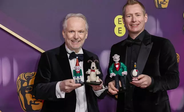 Nick Park, left, and Merlin Crossingham pose for photographers upon arrival at the 78th British Academy Film Awards, BAFTA's, in London, Sunday, Feb. 16, 2025. (Photo by Joel C Ryan/Invision/AP)