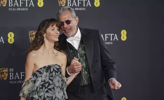 Emilie Livingston, left, and Jeff Goldblum pose for photographers upon arrival at the 78th British Academy Film Awards, BAFTA's, in London, Sunday, Feb. 16, 2025. (Photo by Alberto Pezzali/Invision/AP)