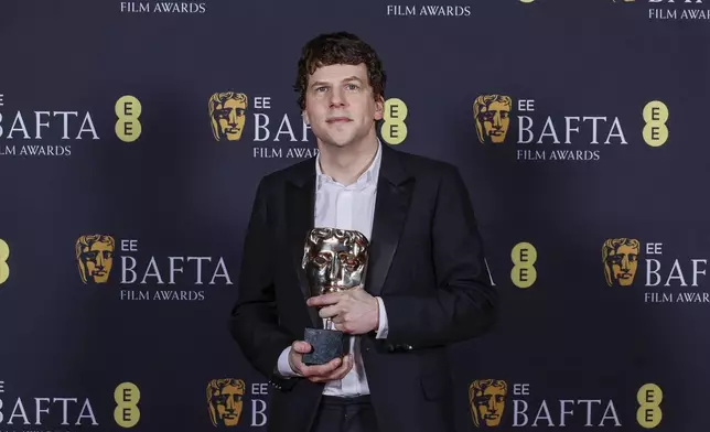 Jesse Eisenberg poses with the best supporting actor award he received on behalf of Kieran Culkin for "A Real Pain" at the 78th British Academy Film Awards, BAFTA's, in London, Sunday, Feb. 16, 2025. (Photo by Joel C Ryan/Invision/AP)