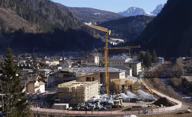 The Olympic village is under construction at the venue for the ski jumping and nordic combined disciplines at the Milan Cortina 2026 Winter Olympics, in Predazzo, Italy, Friday, Jan. 17, 2025. (AP Photo/Luca Bruno)