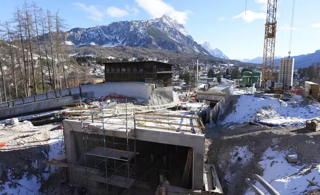 Construction work takes place at the Cortina Sliding Center, venue for the bob, luge and skeleton disciplines, at the Milan Cortina 2026 Winter Olympics, in Cortina d'Ampezzo, Italy, Thursday, Jan. 16, 2025. (AP Photo/Giovanni Auletta)