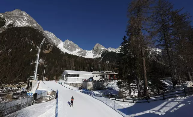 An athlete competes during a Biathlon World Cup event at the Anterselva Biathlon Arena, venue for the biathlon discipline at the Milan Cortina 2026 Winter Olympics, in Anterselva, northern Italy, Saturday, Jan. 25, 2025. (AP Photo/Alessandro Trovati)