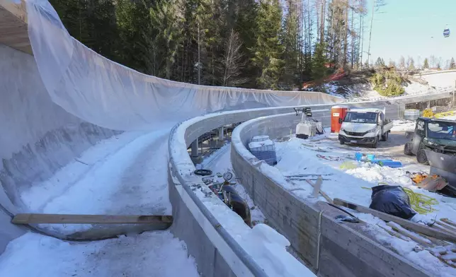 Construction work takes place at the Cortina Sliding Center, venue for the bob, luge and skeleton disciplines at the Milan Cortina 2026 Winter Olympics, in Cortina d'Ampezzo, Italy, Thursday, Jan. 16, 2025. (AP Photo/Giovanni Auletta)