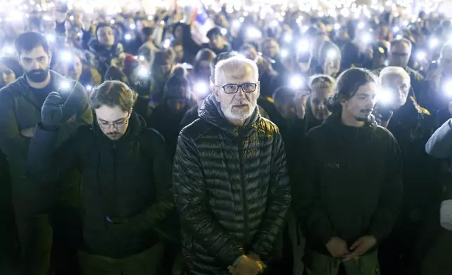 A man stands during a minute of silence ceremony as he protests over the collapse of a concrete canopy killed multiple people more than two months ago, in Novi Sad, Serbia, Sunday, Feb. 2, 2025. (AP Photo/Armin Durgut)