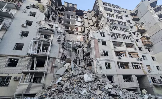 In this photo provided by the Kherson Regional Military Administration on Thursday, Feb. 20, 2025, a building is seen heavily damaged by a Russian strike in Kherson, Ukraine. (Kherson Regional Military Administration via AP)
