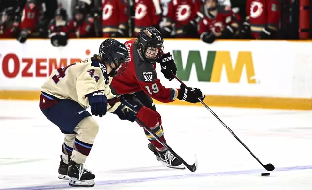 Ottawa Charge's Brianne Jenner (19) skates with the puck against Montreal Victoire's Amanda Boulier (44) during third period PWHL hockey action in Ottawa, on Saturday, Feb. 22, 2025. (Justin Tang/The Canadian Press via AP)