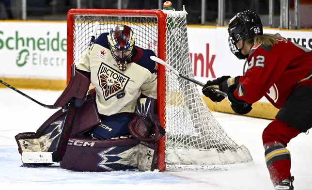 Montreal Victoire goaltender Ann-Renee Desbiens (35) makes a save on Ottawa Charge's Danielle Serdachny (92) during first period PWHL hockey action in Ottawa, on Saturday, Feb. 22, 2025. (Justin Tang/The Canadian Press via AP)