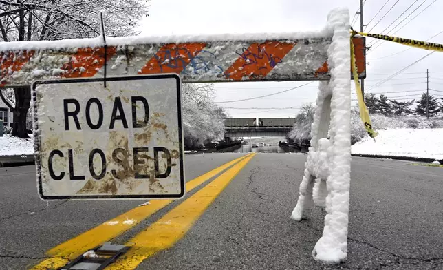 A road is closed due to flooding in Louisville, Ky., Sunday, Feb. 16, 2025. (AP Photo/Timothy D. Easley)