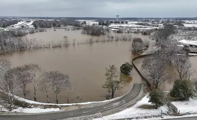 A high-rising Barren River flows through Bowling Green, Ky., Sunday, Feb. 16, 2025, after heavy rainfall beginning early Saturday morning brought nearly five inches of rain and snowfall to Warren County. (Jack Dobbs/Daily News via AP)