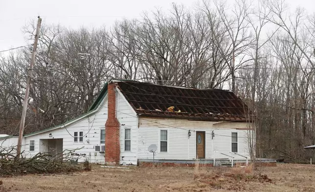 A roof was ripped off and flipped over on a home along Lee County Rd. 449 in Shannon, Miss. during Saturday nights severe thunderstorms that passed through the state. (Thomas Wells/The Northeast Mississippi Daily Journal via AP)