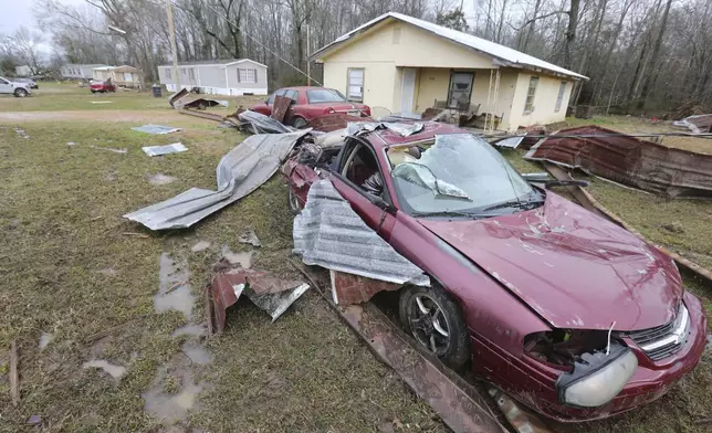 A car sits destroyed along the road in Shannon, Miss., Sunday, Feb. 16, 2025, following Saturday nights storms that passed through Northeast Mississippi. (Thomas Wells/Northeast Mississippi Daily Journal via AP)
