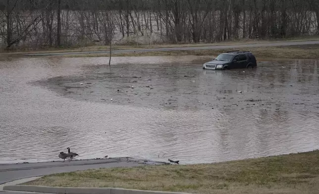 A vehicle sits in flood water along the Red River, Sunday, Feb. 16, 2025, in Clarksville, Tenn. (AP Photo/George Walker IV)