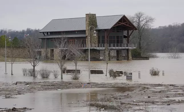 Water from the Cumberland River rises out of its banks Sunday, Feb. 16, 2025, in Clarksville, Tenn. (AP Photo/George Walker IV)