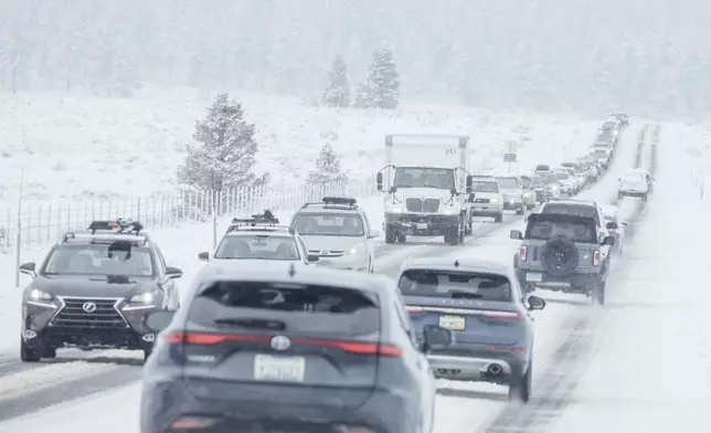 Motorists travel along a snow covered State Route 267 in Truckee, Calif., Friday, Feb. 14, 2025. (Stephen Lam/San Francisco Chronicle via AP)