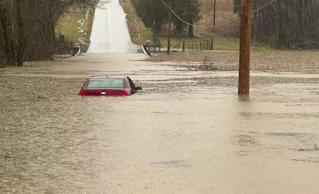 This photo provided by the Warren County, Ky., Sheriff's Office shows a partially submerged car outside of Bowling Green, Ky., on Saturday, Feb. 15, 2025. (Warren County Sheriff's Office via AP)