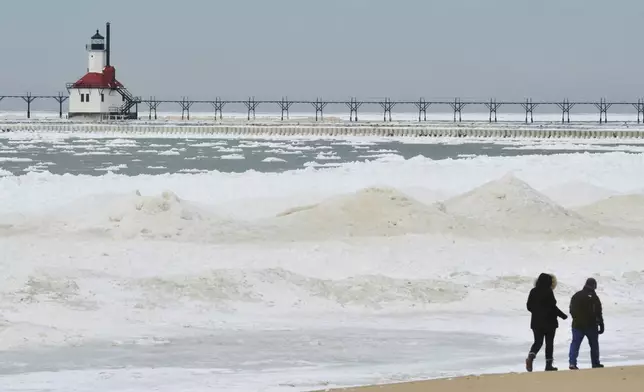 Ice builds up along the Lake Michigan shoreline Friday, Feb. 14, 2025, in St. Joseph, Mich.(Don Campbell/The Herald-Palladium via AP)