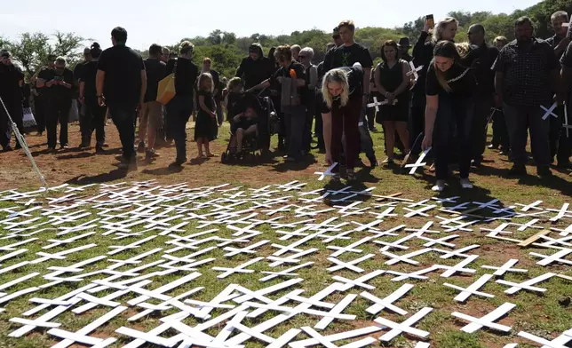 FILE - People place white crosses representing farmers killed in the country at a ceremony at the Vorrtrekker Monument in Pretoria, South Africa, Oct. 30, 2017. (AP Photo, File)