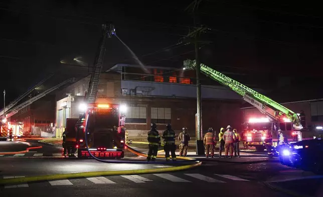 Firefighters battle a blaze at SPS Technologies in Jenkintown, Pa., Monday, Feb. 17, 2025. (AP Photo/Matt Rourke)