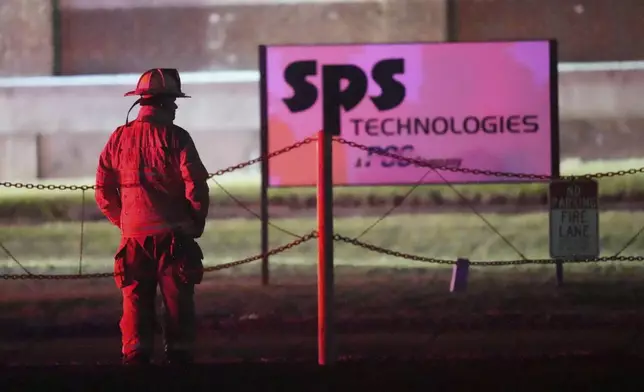 A firefighter looks on as a fire engulfs SPS Technologies in Jenkintown, Pa., Monday, Feb. 17, 2025. (AP Photo/Matt Rourke)