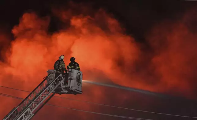 Firefighters battle a blaze at SPS Technologies in Jenkintown, Pa., Monday, Feb. 17, 2025. (AP Photo/Matt Rourke)