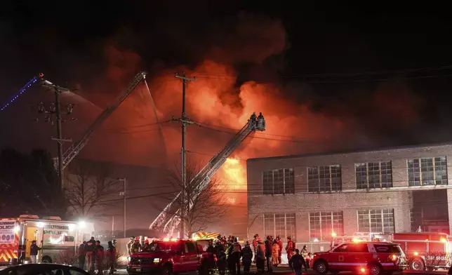 Firefighters battle a blaze at SPS Technologies in Jenkintown, Pa., Monday, Feb. 17, 2025. (AP Photo/Matt Rourke)
