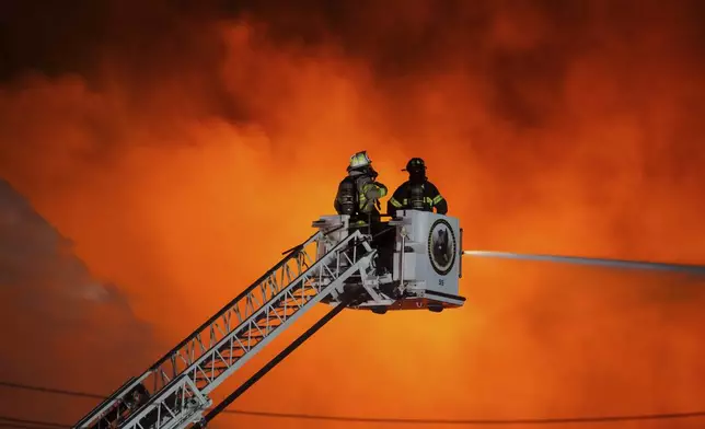 Firefighters battle a blaze at SPS Technologies in Jenkintown, Pa., Monday, Feb. 17, 2025. (AP Photo/Matt Rourke)