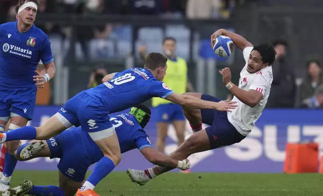 France's Yoram Moefana, right, in action, during the Six Nations rugby union match between Italy and France at the Olympic stadium, in Rome, Sunday, Feb. 23, 2025. (Alfredo Falcone/LaPresse via AP)