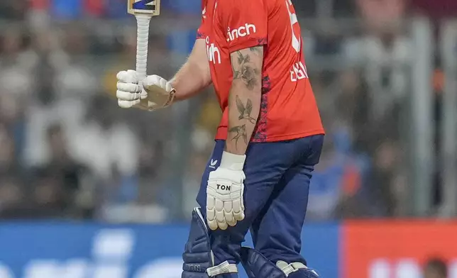 England's Phil Salt raises his bat as he celebrates after scoring fifty runs during the fifth Twenty20 cricket match between India and England at Wankhede Stadium in Mumbai, India, Sunday, Feb. 2, 2025.(AP Photo/Rafiq Maqbool)